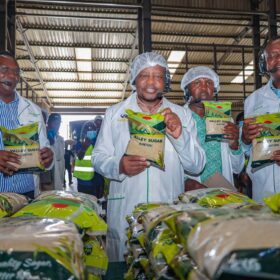 CS Kagwe and Kipchimchim Group officials display packaged sugar during the tour of West Valley Sugar Company.